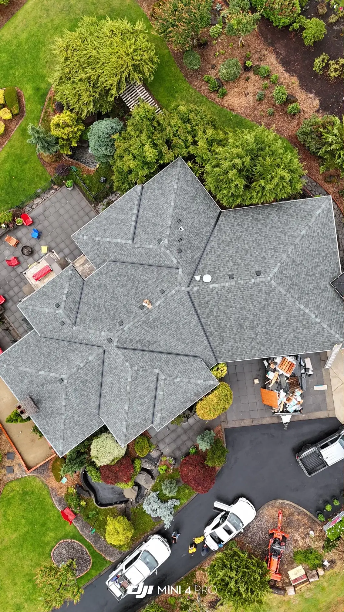 Aerial view of an asphalt shingle roof replacement in progress by Dexica Construction in the Oregon Pacific Northwest
